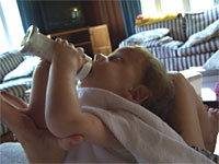 "Holding my bottle... with mom's help"